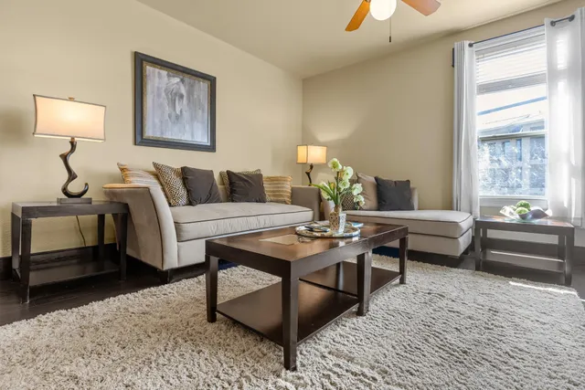 a living room with furniture and a chandelier
