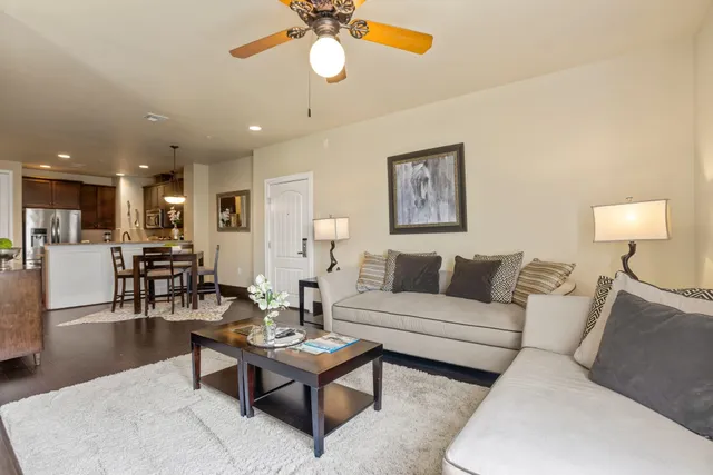 a living room with furniture and floor to ceiling windows