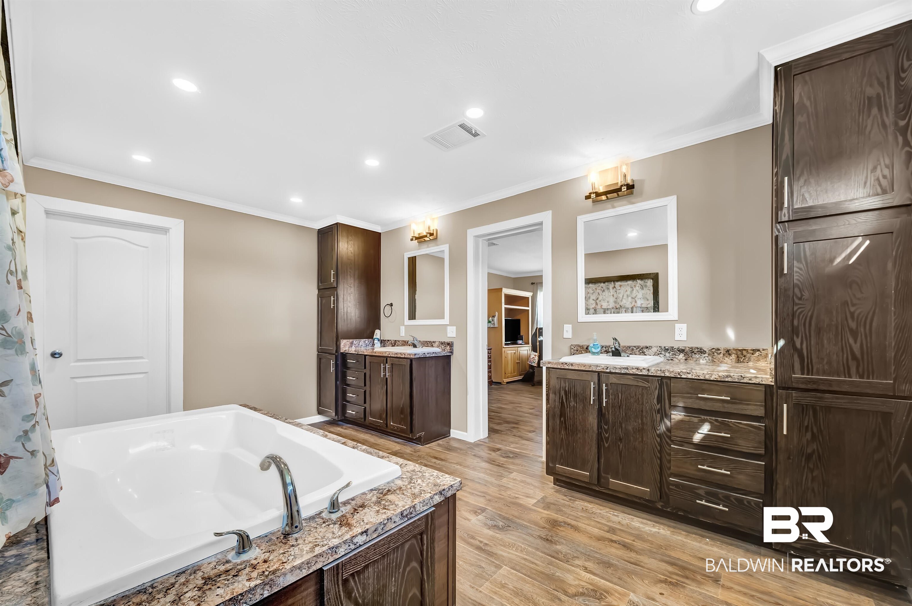 23233 Forland Road Silverhill, AL 36576 - Photo 20 of 33 Ensuite bathroom with crown molding, vanity, wood finished floors, a bath, and visible vents