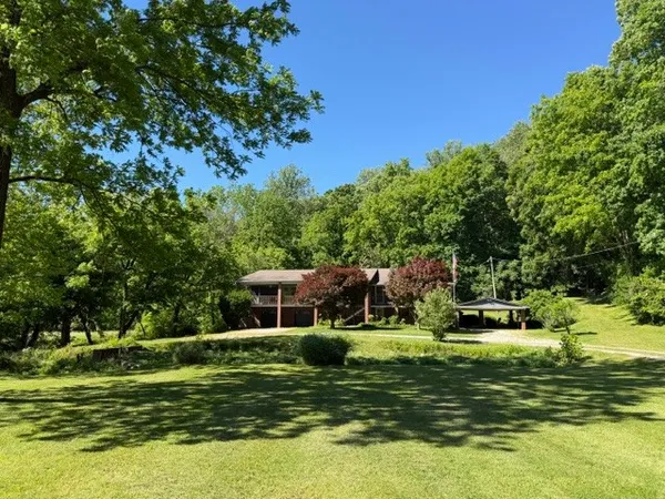 a view of a house with a yard and roof