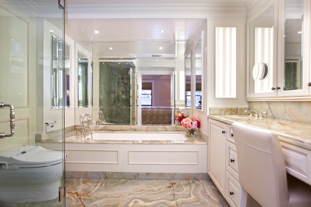 160 Central Park South, Unit 1201 Manhattan, NY 10019 - Photo 12 of 20 a bathroom with a granite countertop bathtub sink vanity mirror and toilet