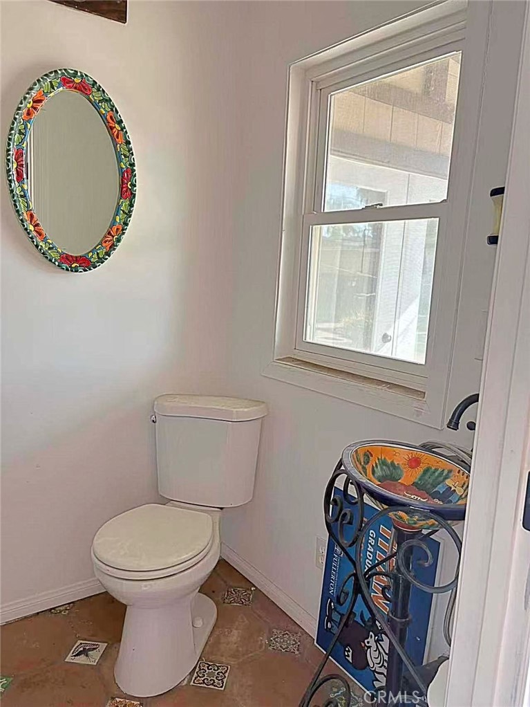 1105 East Walnut Avenue Fullerton, CA 92831 - Photo 15 of 22 a bathroom with a toilet and a mirror