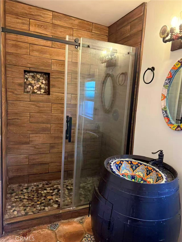 1105 East Walnut Avenue Fullerton, CA 92831 - Photo 21 of 22 a bathroom with a shower and mirror