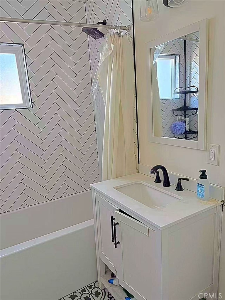 1105 East Walnut Avenue Fullerton, CA 92831 - Photo 6 of 22 a bathroom with a sink a vanity and a bathtub