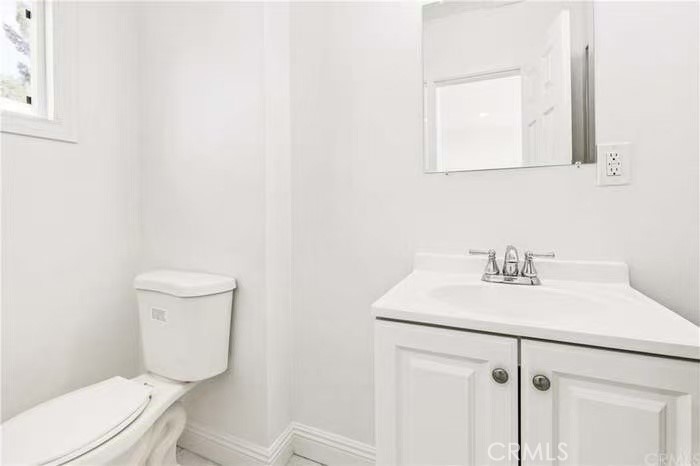1105 East Walnut Avenue Fullerton, CA 92831 - Photo 9 of 22 a bathroom with a sink a toilet and mirror