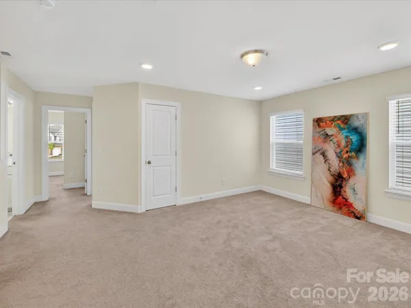 an empty room with furniture and a window