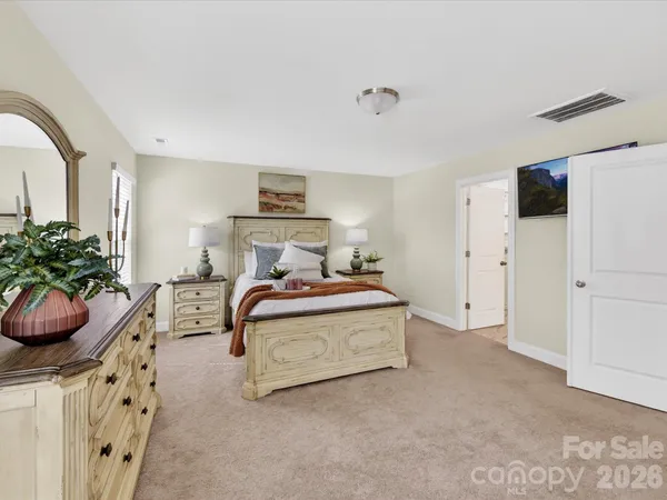 a bedroom with a bed and a potted plant