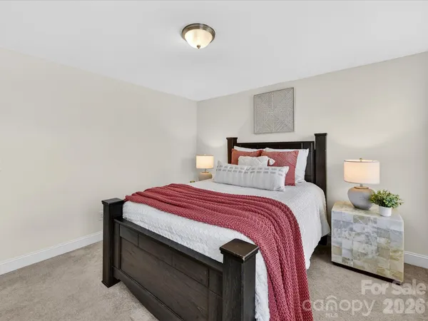 a bedroom with a bed and a potted plant