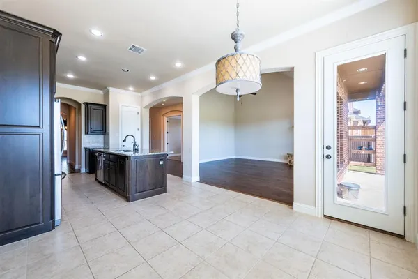 a large kitchen with a large counter top stainless steel appliances and cabinets