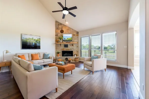 a living room with fireplace furniture and a flat screen tv