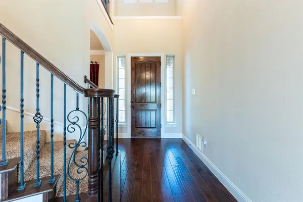 a view of an entryway with wooden floor