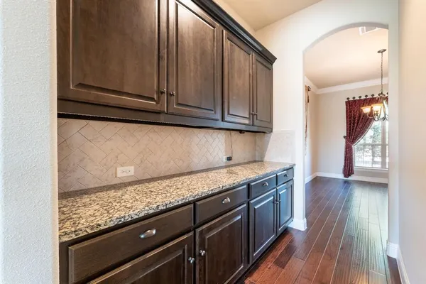 a kitchen with granite countertop cabinets stainless steel appliances and a counter space