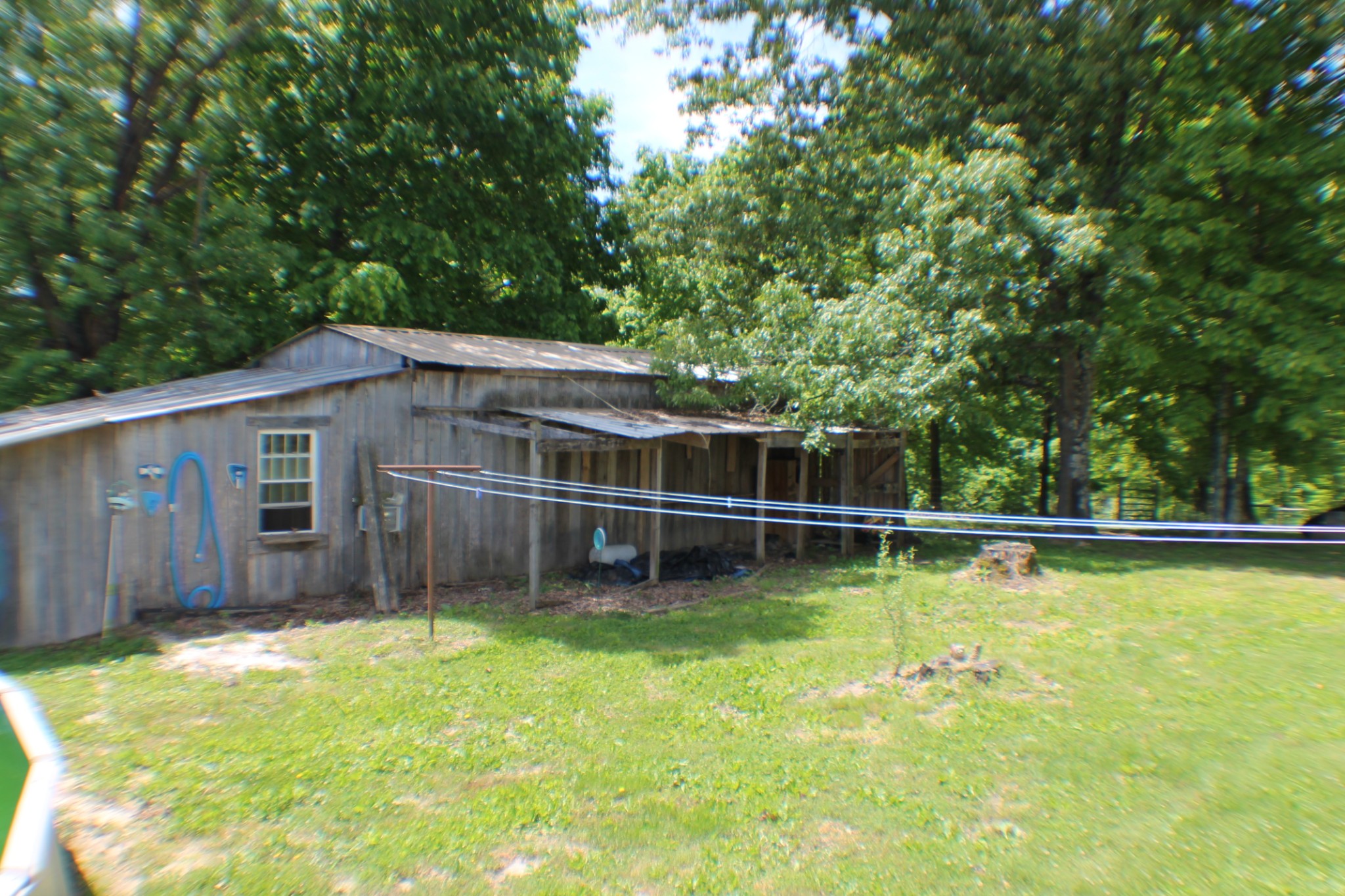 985 Archer Road Lafayette, TN 37083 - Photo 24 of 26 a backyard of a house with lawn chairs and wooden fence