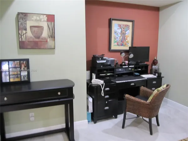 a room with furniture and paintings on the wall