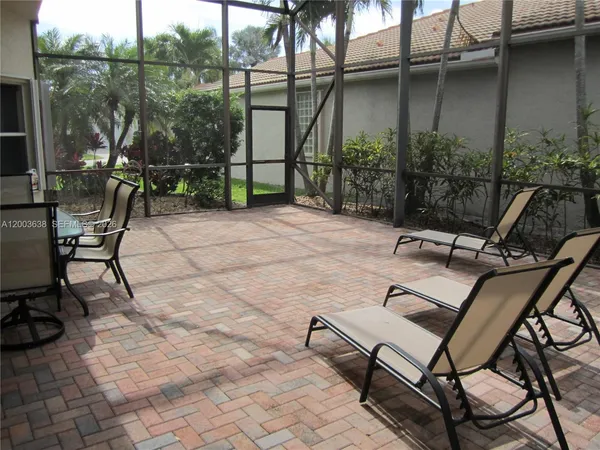 a view of backyard with outdoor seating and plants