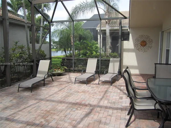 a view of backyard with outdoor seating and plants