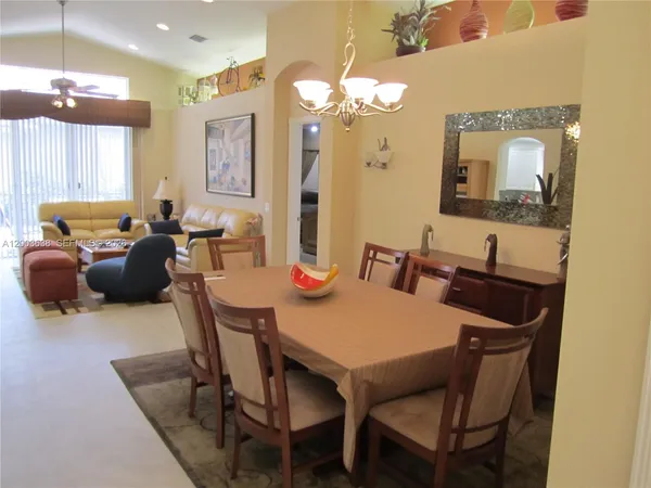 a view of a dining room with furniture and a chandelier