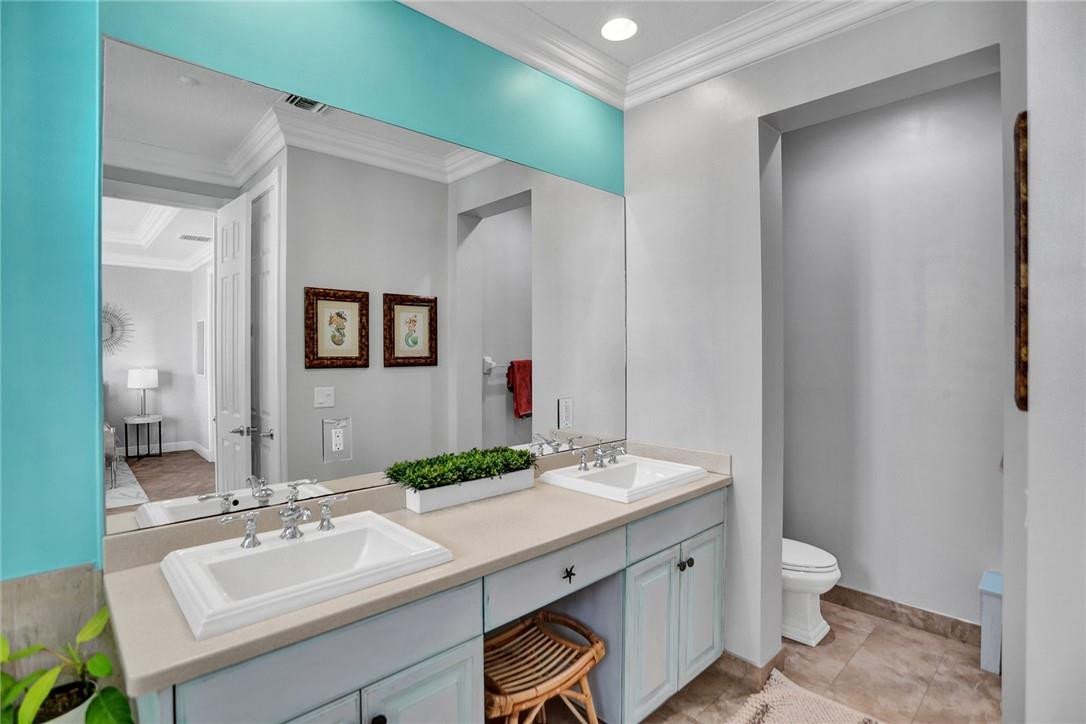 2820 Marina Circle Lighthouse Point, FL 33064 - Photo 15 of 37 a bathroom with a granite countertop sink toilet and mirror