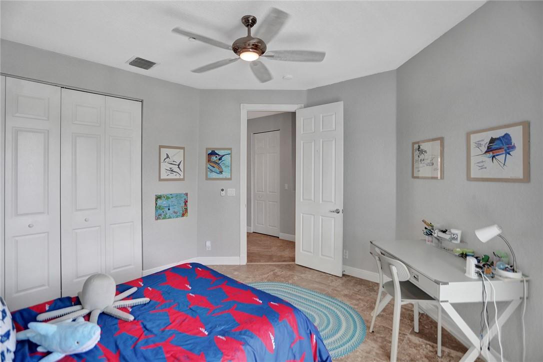 2820 Marina Circle Lighthouse Point, FL 33064 - Photo 18 of 37 a bedroom with a bed and a chandelier