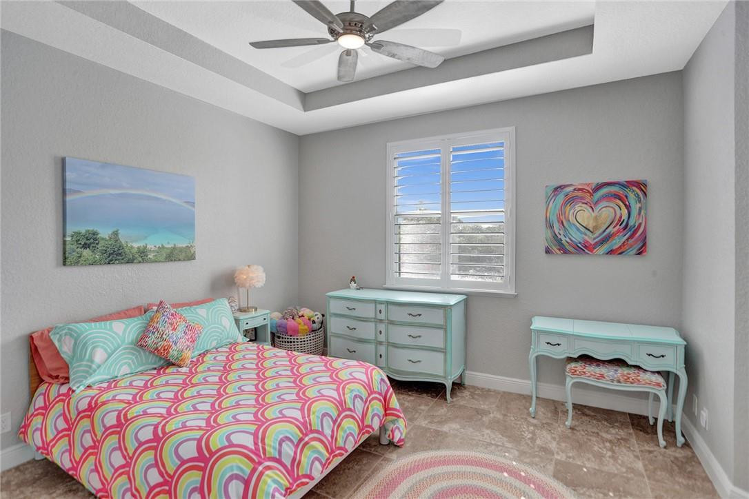 2820 Marina Circle Lighthouse Point, FL 33064 - Photo 19 of 37 a bedroom with a bed and a chandelier