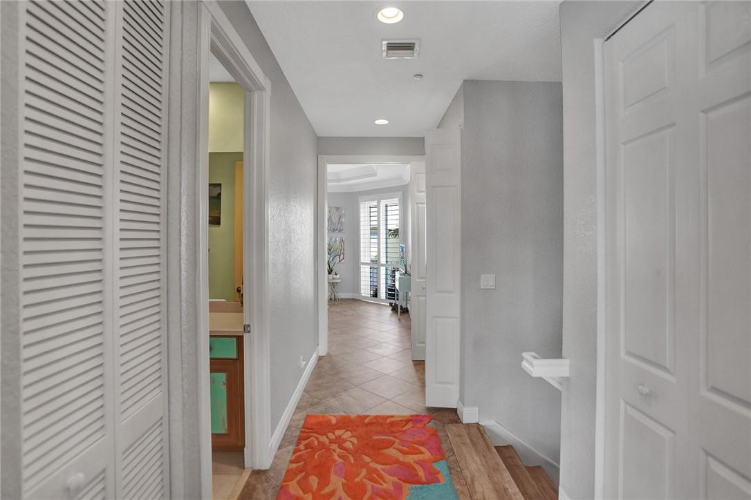 2820 Marina Circle Lighthouse Point, FL 33064 - Photo 21 of 37 a view of a hallway with wooden floor and a bathroom