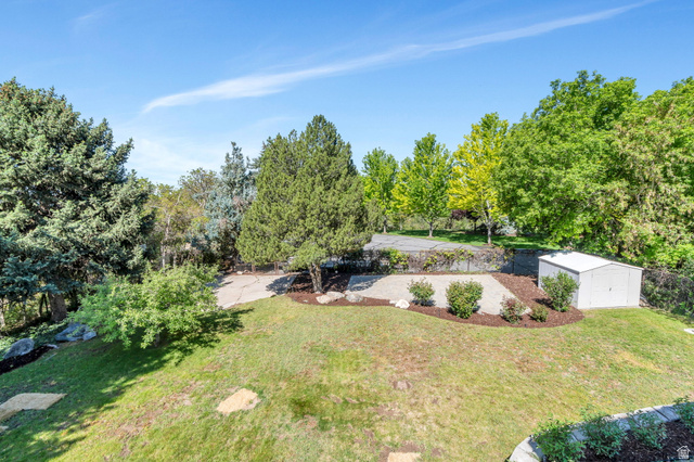3813 North Foothill Drive Provo, UT 84604 - Photo 58 of 71 Expansive outdoor space featuring a sloped lawn, concrete patio, and a storage shed