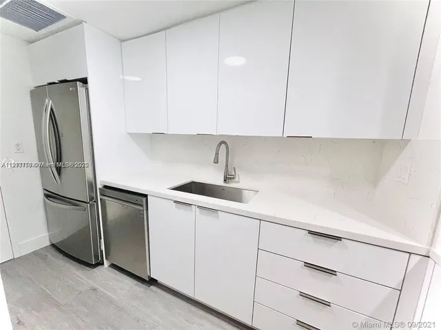 a kitchen with a sink stainless steel appliances and cabinets