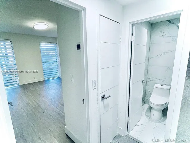 a bathroom with a toilet and a shower