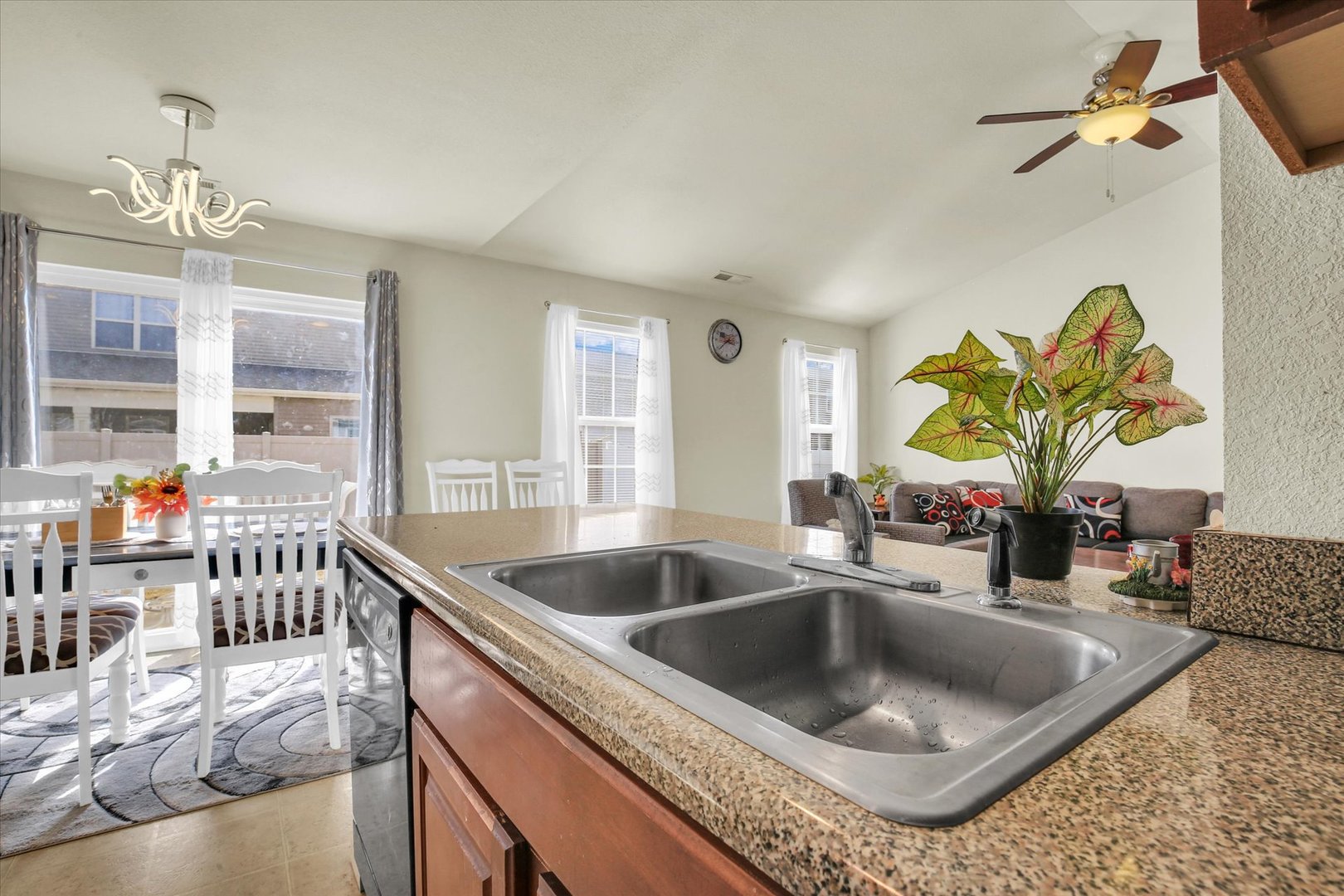 501 Luria Lane Champaign, IL 61822 - Photo 18 of 33 a kitchen with a sink a counter top space and living room view