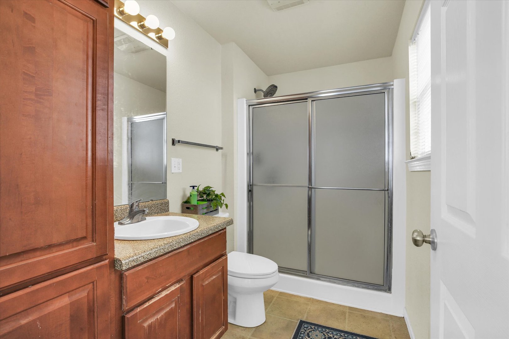 501 Luria Lane Champaign, IL 61822 - Photo 22 of 33 a bathroom with a granite countertop sink toilet and shower