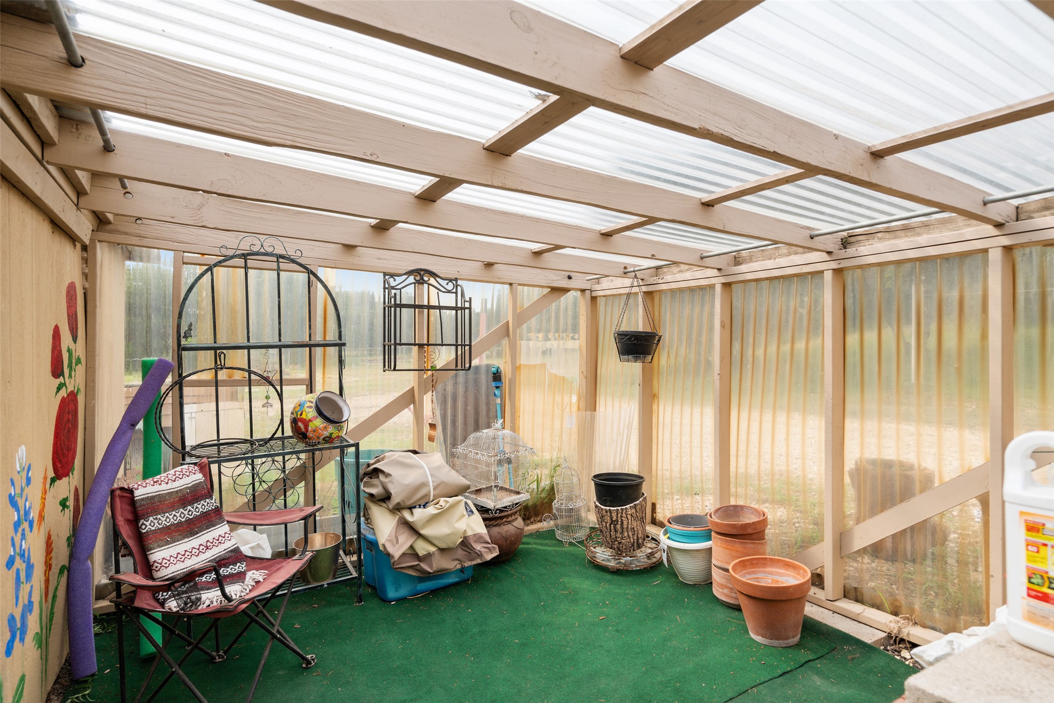 23200 Fulkes Road Leander, TX 78641 - Photo 10 of 15 A charming, sun-drenched greenhouse provides a tranquil space for gardening endeavors.