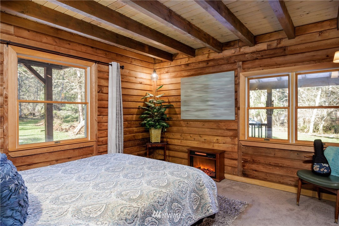 230 Eliza Road Lopez Island, WA 98261 - Photo 11 of 26 a bedroom with a bed and a window