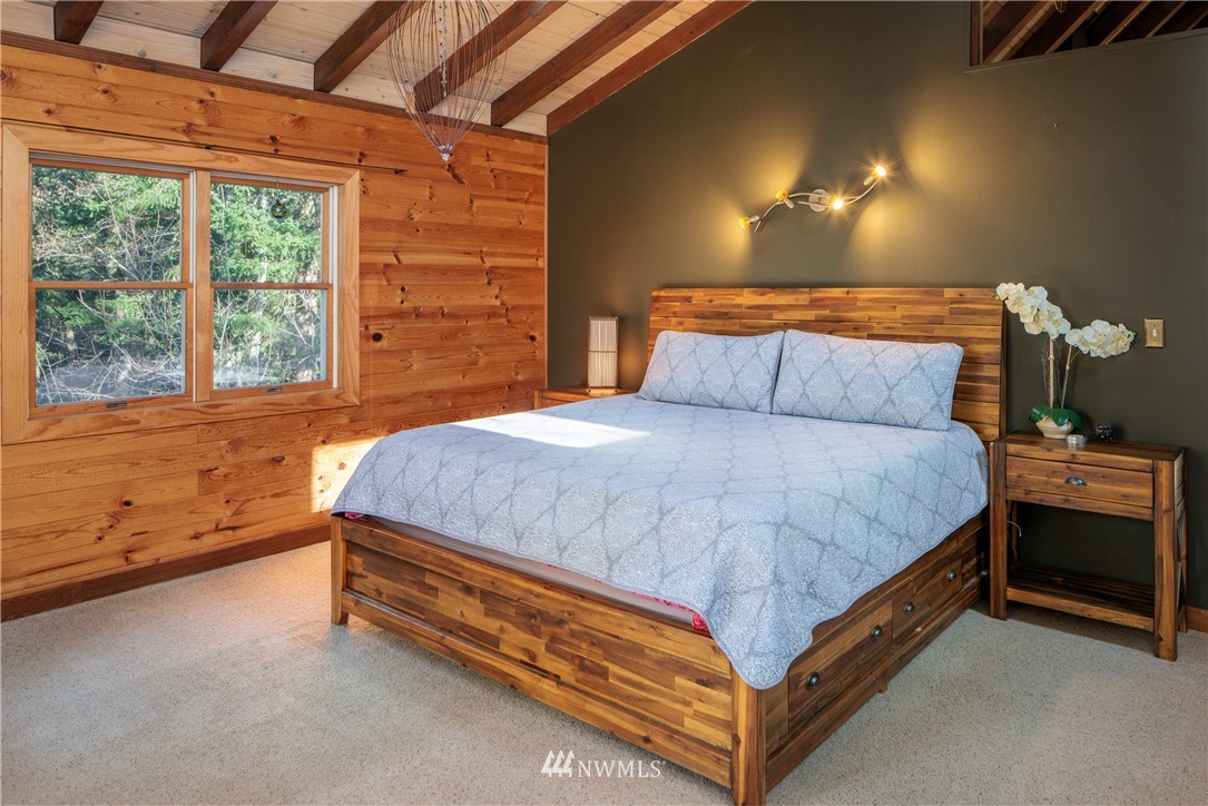 230 Eliza Road Lopez Island, WA 98261 - Photo 13 of 26 a bed sitting in a bedroom next to a window