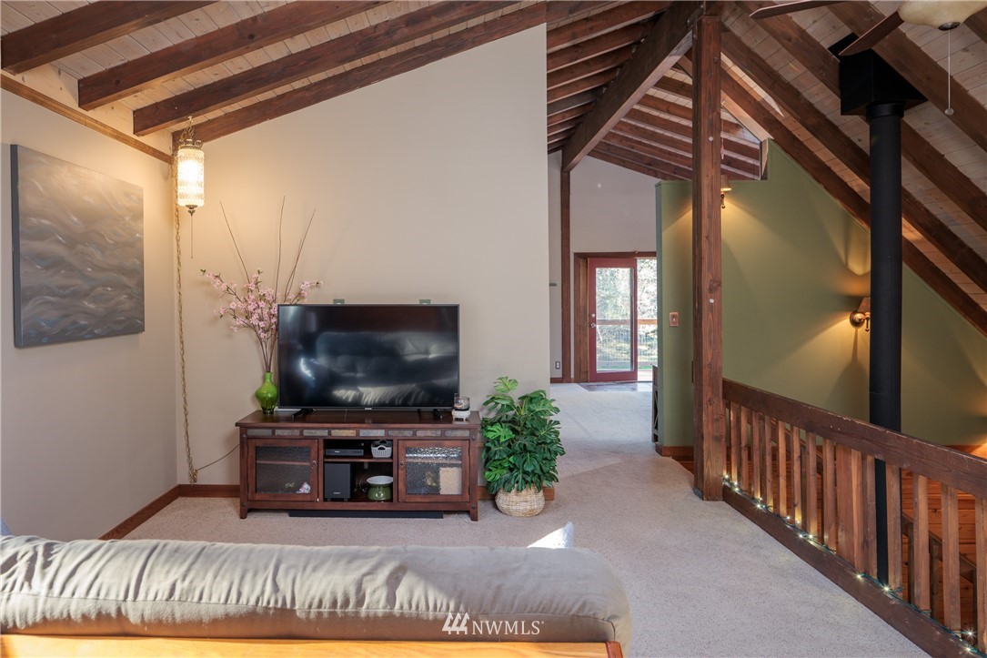 230 Eliza Road Lopez Island, WA 98261 - Photo 18 of 26 a living room with furniture and a flat screen tv