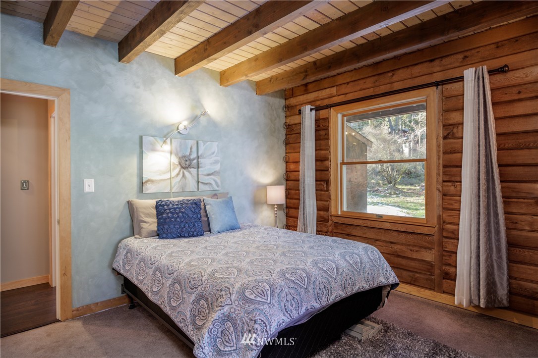 230 Eliza Road Lopez Island, WA 98261 - Photo 10 of 26 a bedroom with a bed and a window