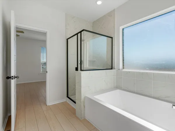 a bathroom with a bathtub and a shower