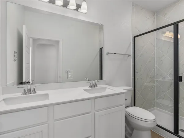 a bathroom with a sink toilet and mirror