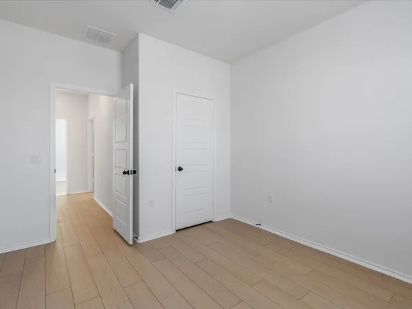 an empty room with wooden floor