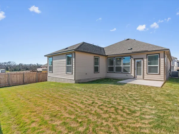 a backyard of a house with wooden fence