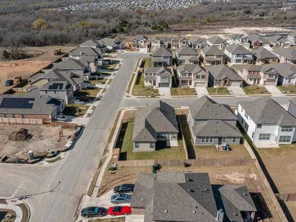 an aerial view of residential houses with outdoor space