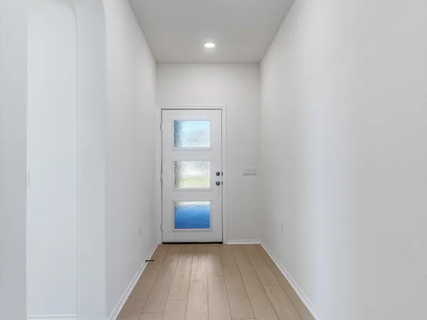a view of hallway with a sink and a mirror