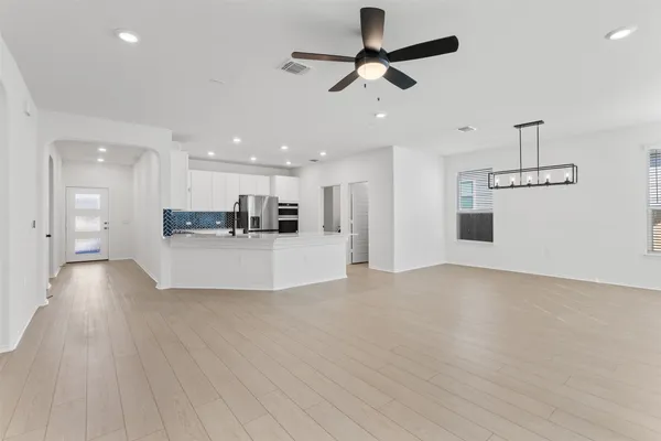 a view of a kitchen with a sink and wooden floor