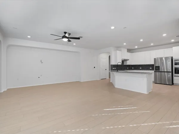 a view of kitchen with granite countertop a sink and a stove