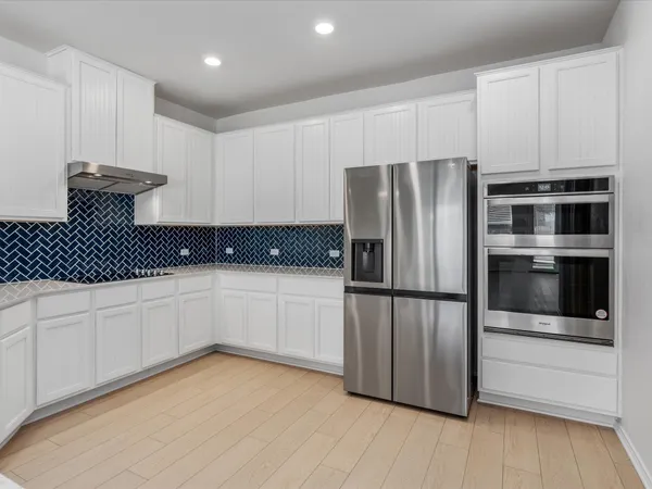 a kitchen with stainless steel appliances a refrigerator sink and microwave