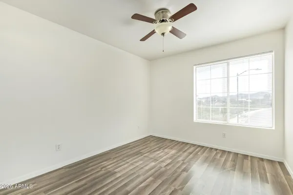a bathroom with a granite countertop toilet sink and mirror