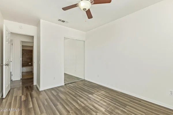 a view of empty room with wooden floor