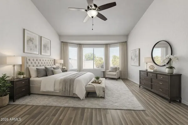 a spacious bedroom with a bed a mirror and window