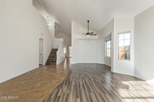 a view of empty room with wooden floor and window
