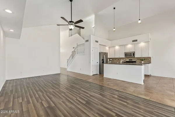 a view of kitchen with refrigerator and microwave