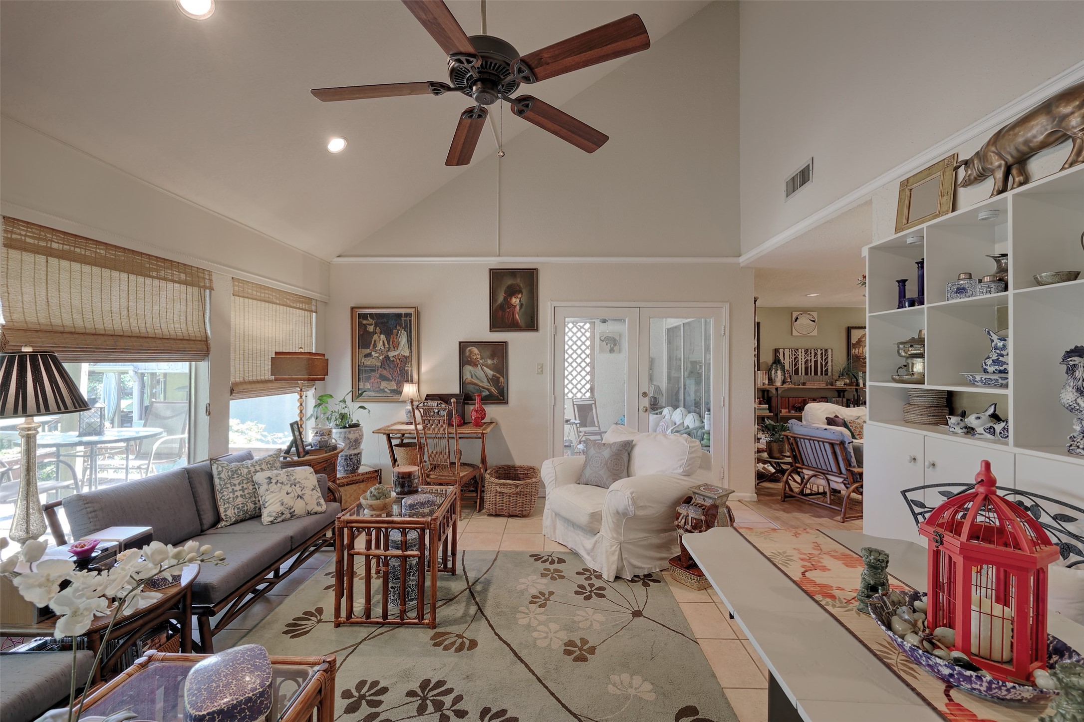 34 April Hill Conroe, TX 77356 - Photo 12 of 33 The large family room features a vaulted ceiling for an open and airy feel. Glass double doors lead to the screened in porch and stairs to the second level.